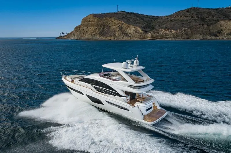 Slide: The Image of Luxury Princess F55 yacht cruising near rocky coastline, 2022 model. - 1