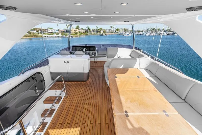 Slide: The Image of Luxurious 2022 Princess F55 yacht interior with spacious seating and scenic marina view. - 28