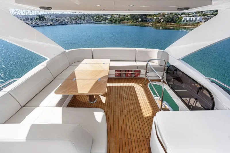 Slide: The Image of Luxurious 2022 Princess F55 yacht deck with elegant seating and scenic water view. - 29