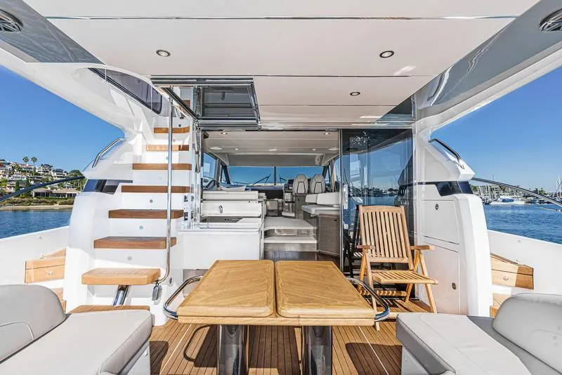 Slide: The Image of Luxurious 2022 Princess F55 yacht interior with wooden furniture and scenic ocean view. - 41