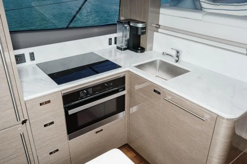 Slide: The Image of Modern kitchen in 2022 Princess F55 yacht with sleek appliances and white countertops. - 49