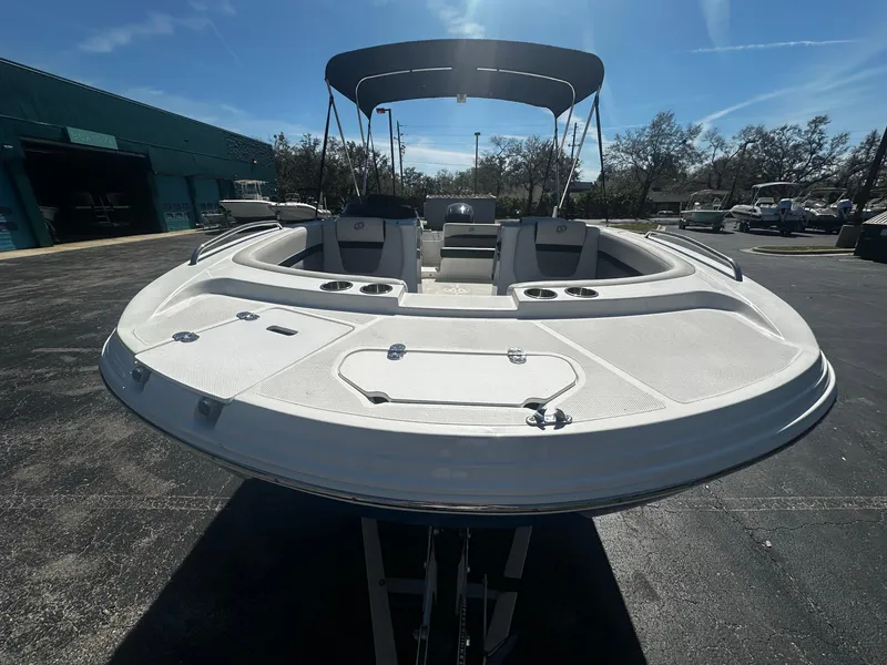 Slide: The Image of 2022 Hurricane SS 192RL boat with canopy, docked outdoors under clear sky. - 2