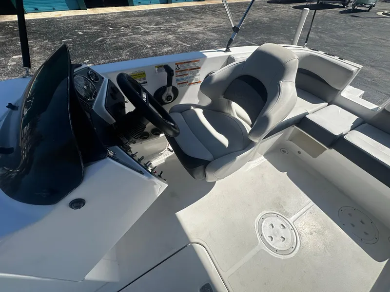 Slide: The Image of 2022 Hurricane SS 192RL boat interior with steering wheel and seating area. - 9