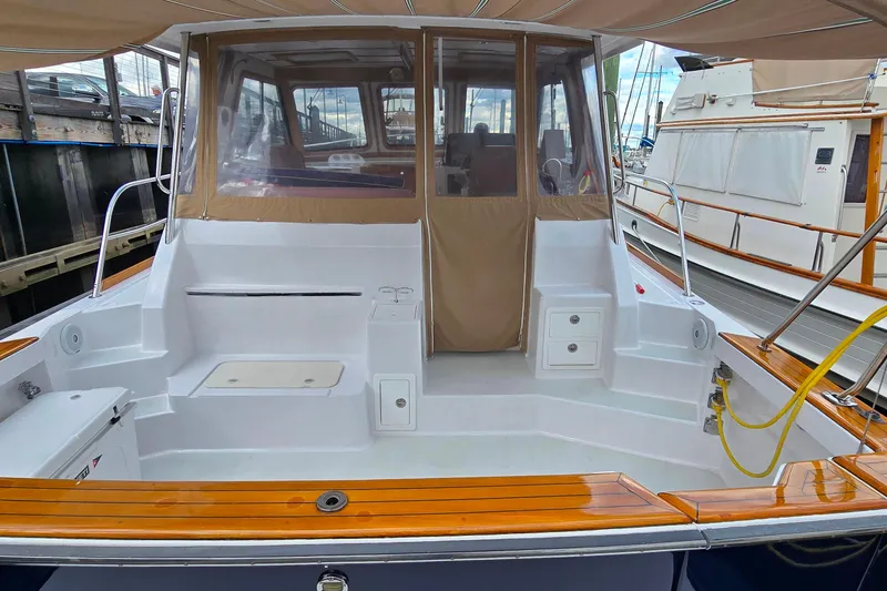 Slide: The Image of 2005 Sabre 38 Express Cruiser with spacious cockpit and teak accents at marina. - 1