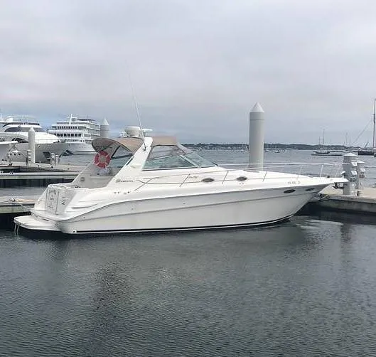Slide: The Image of 2000 Sea Ray 340 Sundancer yacht docked at marina, overcast sky. - 0