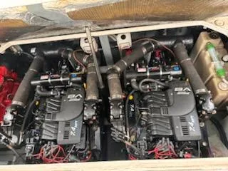 Slide: The Image of Twin engines in a 2000 Sea Ray 340 Sundancer boat, showcasing detailed mechanical components. - 11