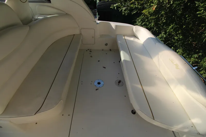 Slide: The Image of 2000 Sea Ray 340 Sundancer boat interior with beige seating and deck. - 13
