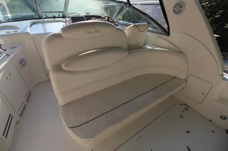 Slide: The Image of 2000 Sea Ray 340 Sundancer boat interior with beige seating and helm. - 14