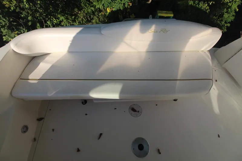 Slide: The Image of 2000 Sea Ray 340 Sundancer boat deck with seating, surrounded by foliage. - 15