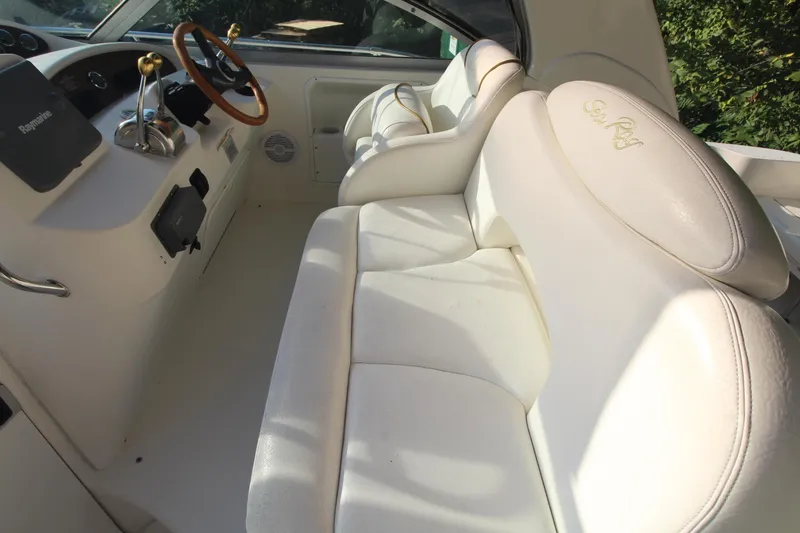 Slide: The Image of Interior of 2000 Sea Ray 340 Sundancer with white leather seating and helm. - 18