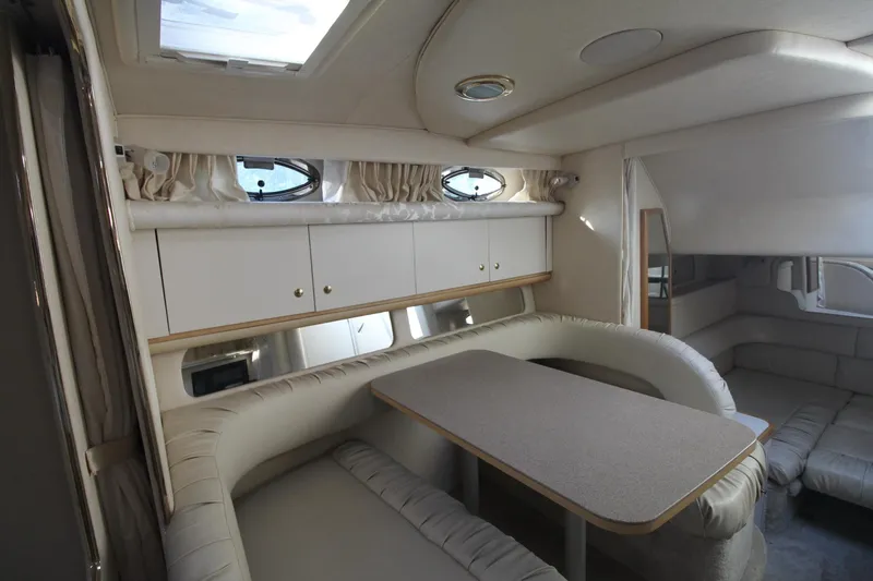 Slide: The Image of Interior of 2000 Sea Ray 340 Sundancer yacht with cozy seating and table. - 24