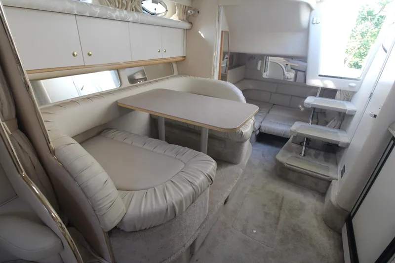 Slide: The Image of Interior of 2000 Sea Ray 340 Sundancer yacht with plush seating and dining area. - 26