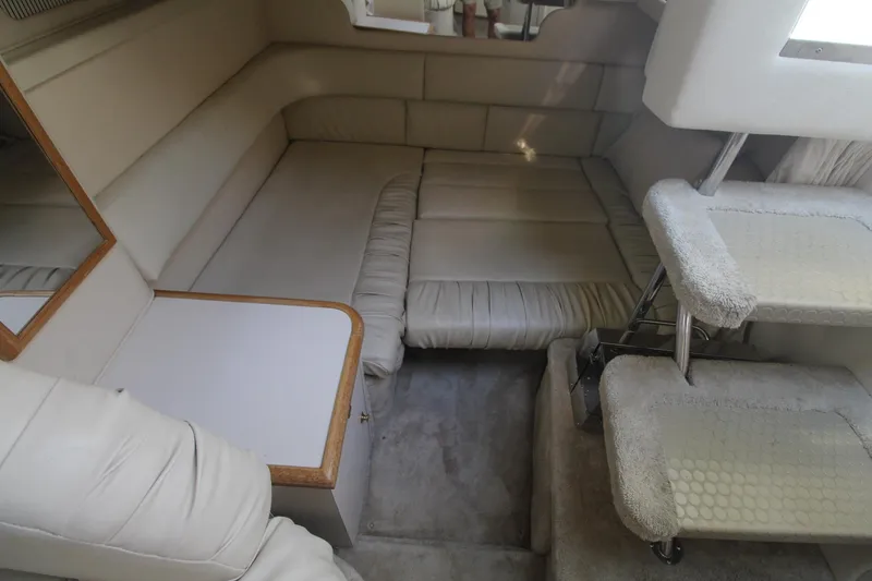 Slide: The Image of Interior of 2000 Sea Ray 340 Sundancer with beige seating and compact table. - 27