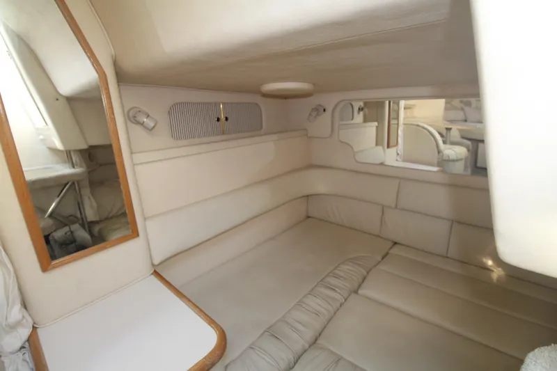 Slide: The Image of Interior cabin of 2000 Sea Ray 340 Sundancer, featuring beige upholstery and a mirror. - 29