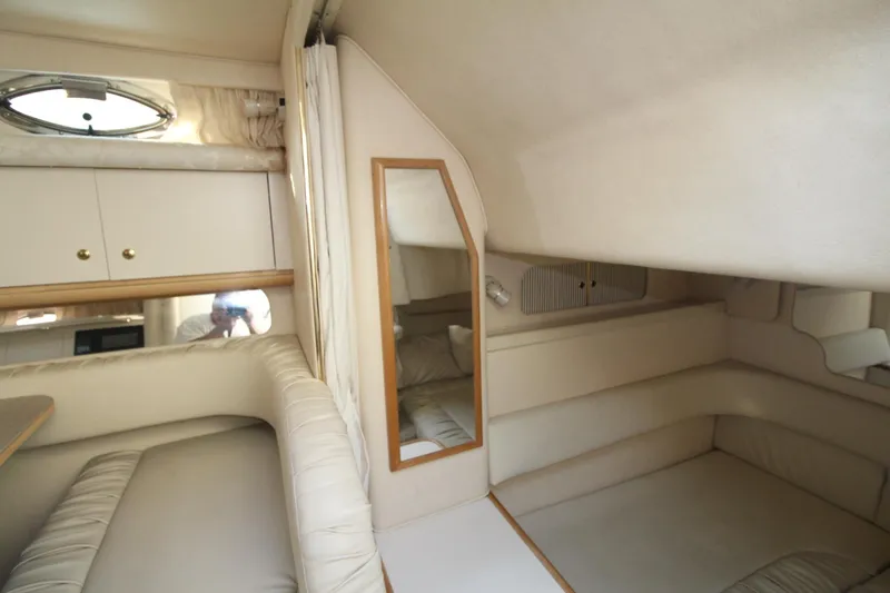 Slide: The Image of Interior of 2000 Sea Ray 340 Sundancer yacht, featuring beige seating and cabinetry. - 31