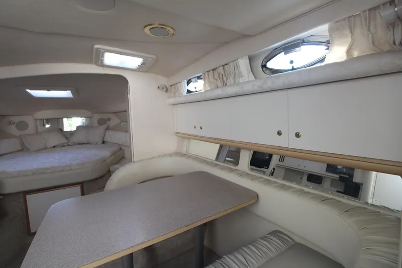 Slide: The Image of Interior of 2000 Sea Ray 340 Sundancer yacht with dining area and sleeping quarters. - 33