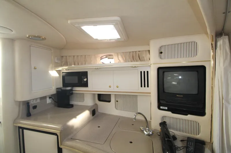 Slide: The Image of Interior of 2000 Sea Ray 340 Sundancer with kitchenette, microwave, and TV. - 34