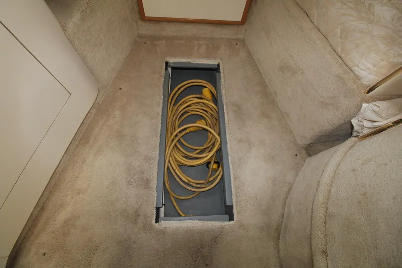 Slide: The Image of Floor storage compartment with yellow cable on 2000 Sea Ray 340 Sundancer boat. - 37