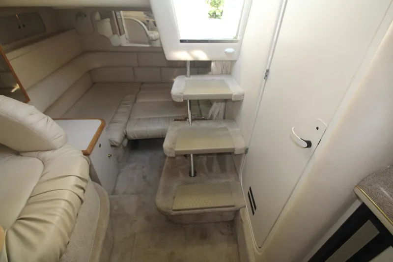 Slide: The Image of Interior of 2000 Sea Ray 340 Sundancer yacht with beige seating and compact stairs. - 38