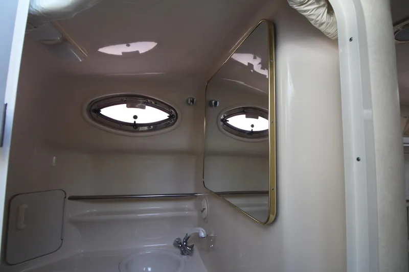 Slide: The Image of Interior of 2000 Sea Ray 340 Sundancer bathroom with oval windows and mirror. - 42
