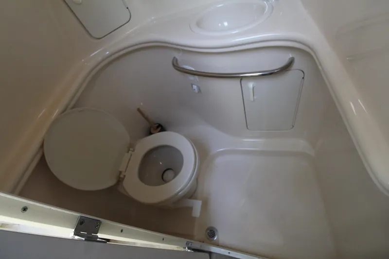Slide: The Image of Compact bathroom in 2000 Sea Ray 340 Sundancer boat, featuring toilet and sink. - 43