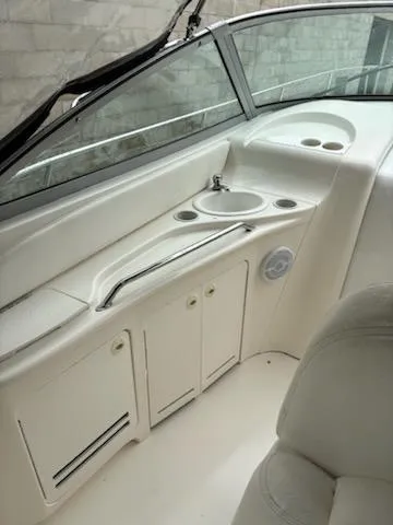 Slide: The Image of 2000 Sea Ray 340 Sundancer boat interior with sink and storage cabinets. - 44