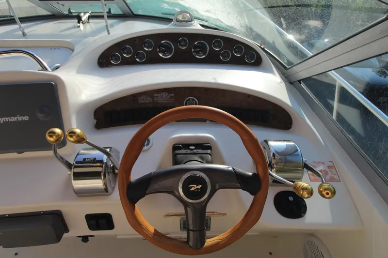 Slide: The Image of Steering wheel and controls of a 2000 Sea Ray 340 Sundancer boat cockpit. - 6