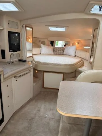 Slide: The Image of Interior of 2000 Sea Ray 340 Sundancer yacht with cozy bed and kitchenette. - 8
