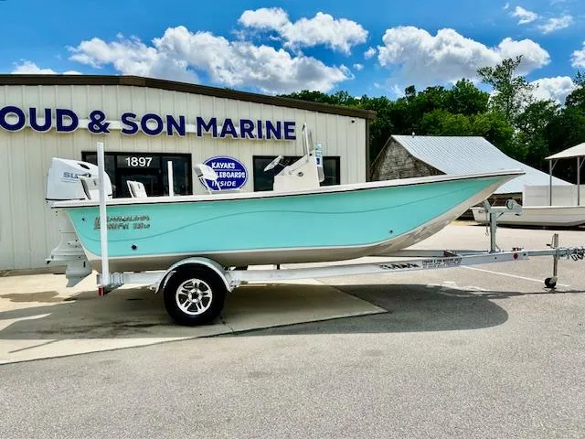 The Image of 2025 Carolina Skiff 19 LS boat on trailer outside marine shop. - 0