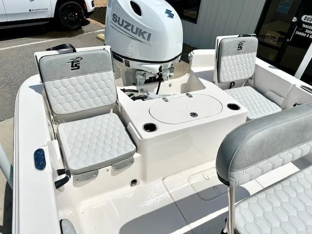 Slide: The Image of 2025 Carolina Skiff 19 LS boat interior with Suzuki engine and cushioned seating. - 11