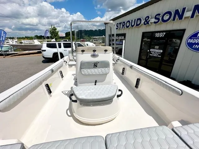 Slide: The Image of 2025 Carolina Skiff 19 LS boat interior at dealership, featuring seating and console. - 13