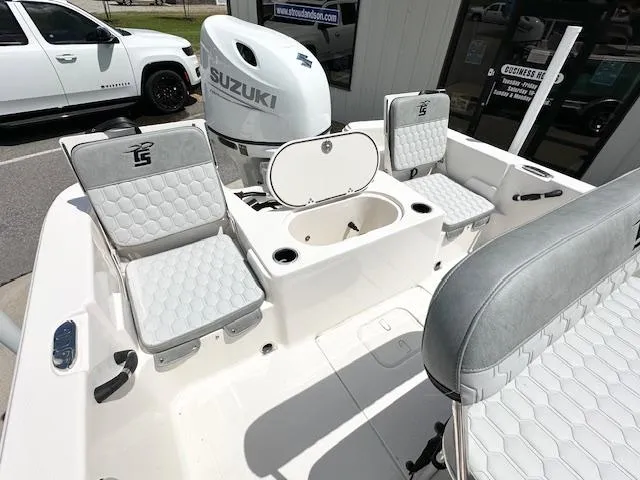 Slide: The Image of 2025 Carolina Skiff 19 LS boat interior with Suzuki engine and cushioned seating. - 19