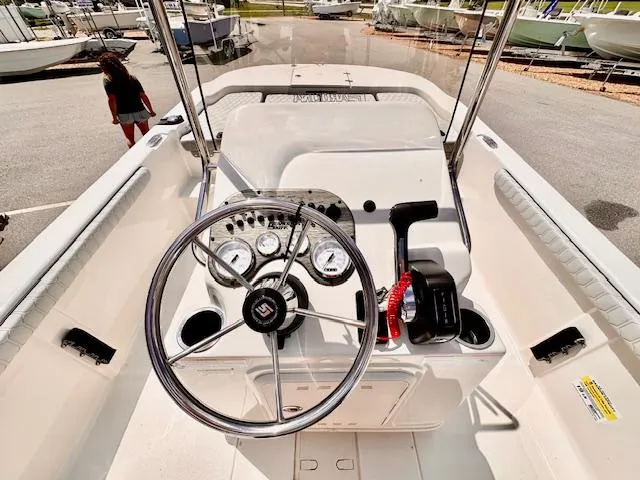 Slide: The Image of 2025 Carolina Skiff 19 LS boat dashboard with steering wheel and controls. - 2