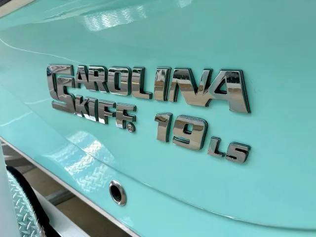 Slide: The Image of 2025 Carolina Skiff 19 LS logo on light blue boat hull. - 21