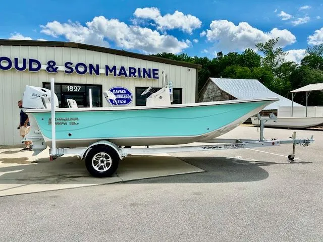 Slide: The Image of 2025 Carolina Skiff 19 LS boat on trailer outside marine shop. - 22