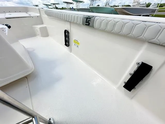 Slide: The Image of 2025 Carolina Skiff 19 LS boat interior with padded seating and clean white deck. - 6