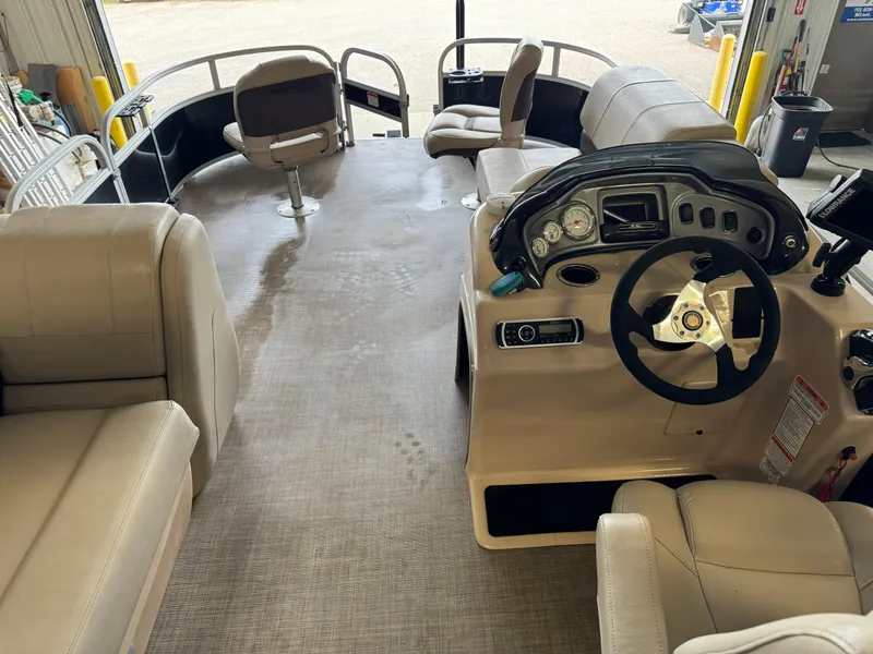 Slide: The Image of 2019 Sun Tracker Fishin' Barge 20 DLX interior with seating and steering console. - 16