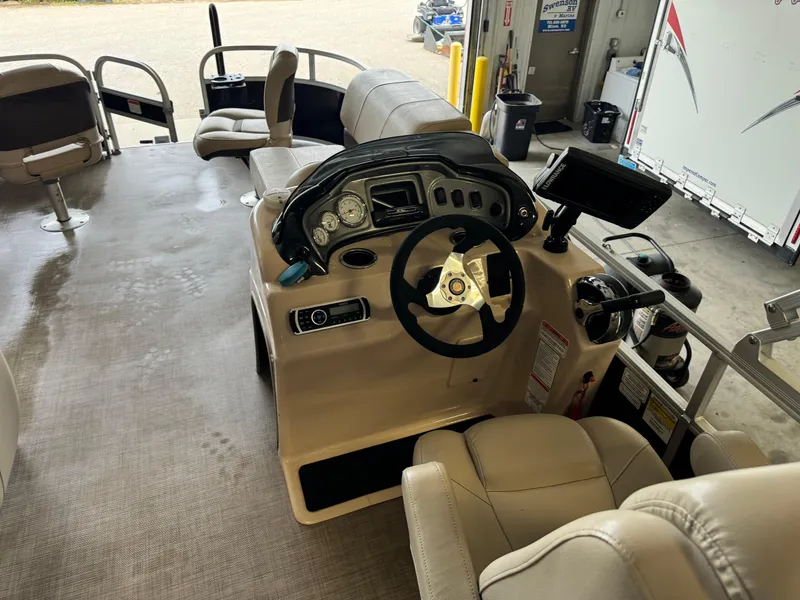 Slide: The Image of 2019 Sun Tracker Fishin' Barge 20 DLX interior with steering console and seating. - 17
