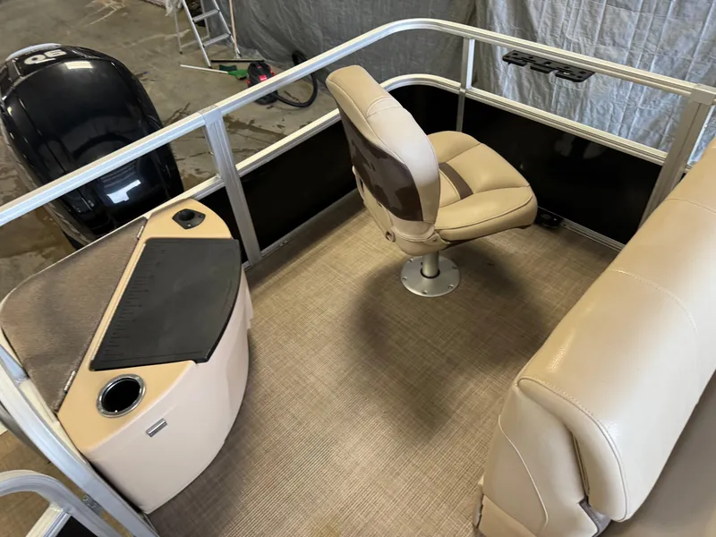 Slide: The Image of 2019 Sun Tracker Fishin' Barge 20 DLX interior with seating and console. - 20