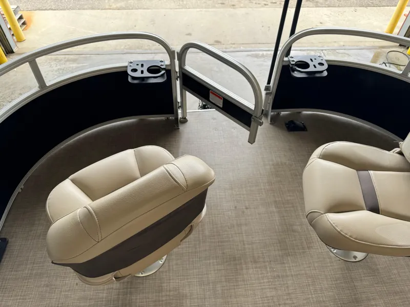 Slide: The Image of 2019 Sun Tracker Fishin' Barge 20 DLX interior with two beige seats and rod holders. - 6