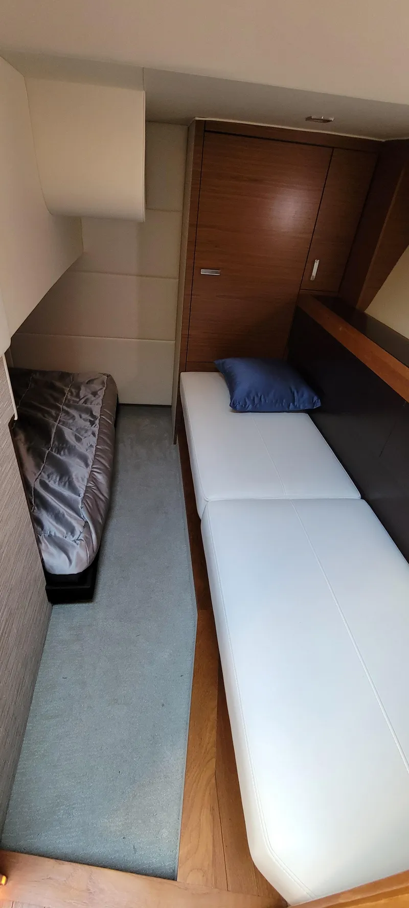 Slide: The Image of Interior cabin of 2018 Tiara Yachts 39, featuring modern bedding and wood accents. - 18