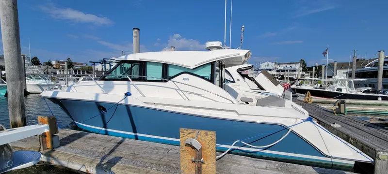 Slide: The Image of 2018 Tiara Yachts 39 docked at marina under clear blue sky. - 3