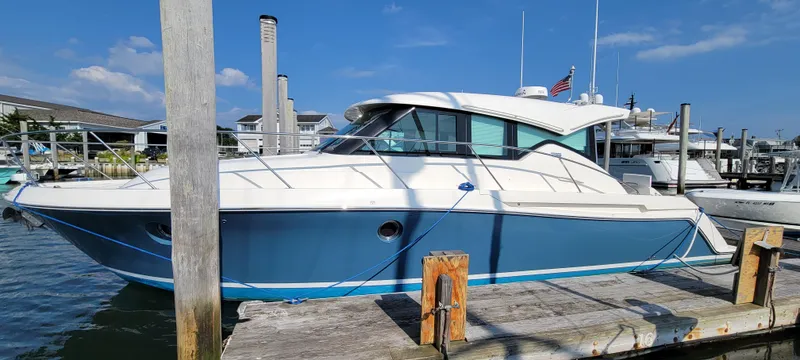 Slide: The Image of 2018 Tiara Yachts 39 docked at marina under clear blue sky. - 4