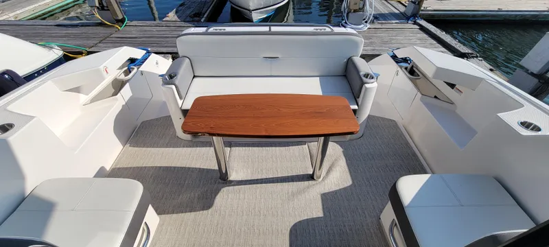 Slide: The Image of Spacious seating area on 2018 Tiara Yachts 39 with wooden table and cushioned seats. - 7