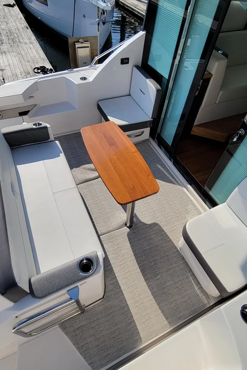 Slide: The Image of 2018 Tiara Yachts 39 interior with seating and wooden table. - 9