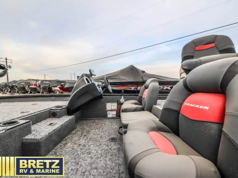 Slide: The Image of 2025 Pro Team 175 TXW boat interior with cushioned seats, steering console, and Bretz RV & Marine logo. - 14