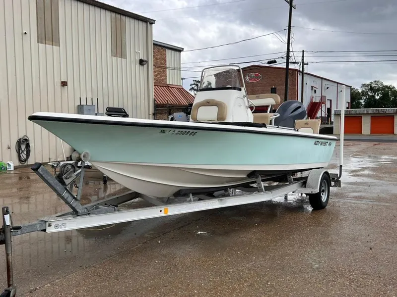 Slide: The Image of 2016 Key West 210 Bay Reef boat on trailer in industrial area. - 6