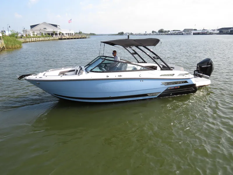 Slide: The Image of 2025 Monterey 255 Super Sport boat cruising on a calm lake. - 0