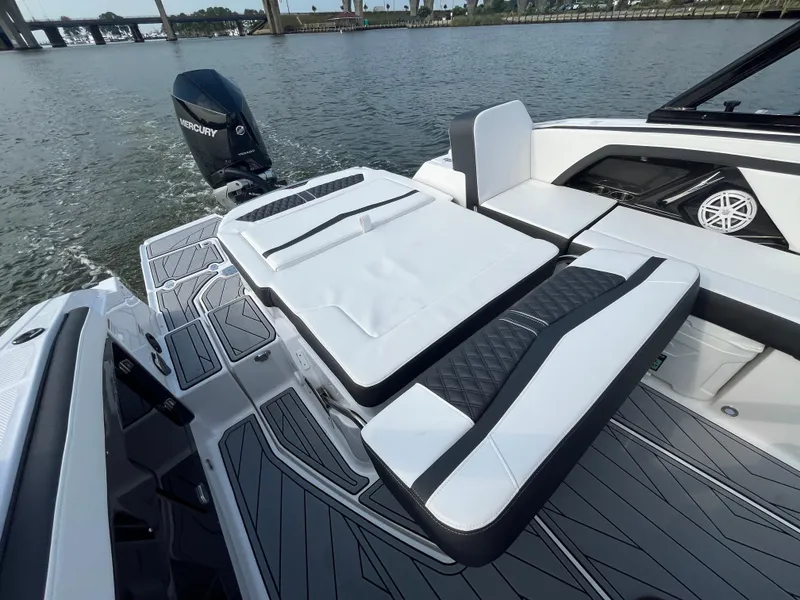 Slide: The Image of 2025 Monterey 255 Super Sport boat with sleek seating and Mercury engine on a calm river. - 13