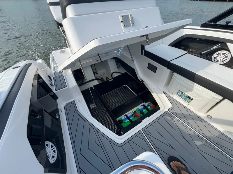 Slide: The Image of 2025 Monterey 255 Super Sport boat with open storage compartment on deck. - 14